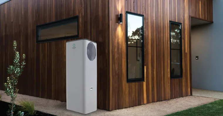 Emerald heat pump installed beside a timber-clad house
