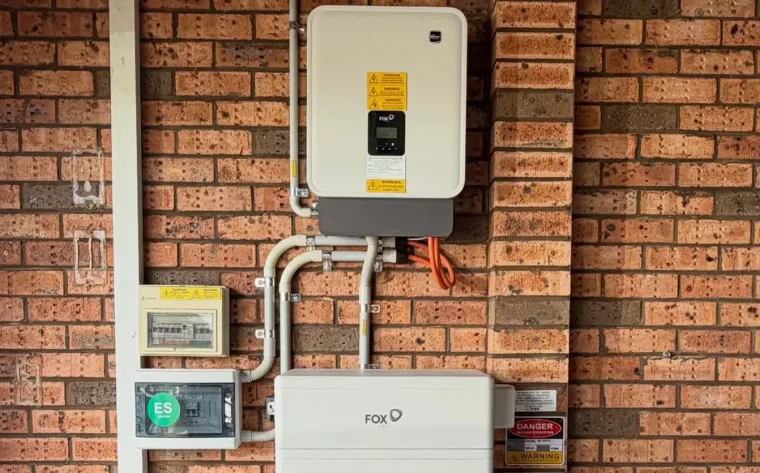 FoxESS hybrid inverter and battery installed on a brick house wall