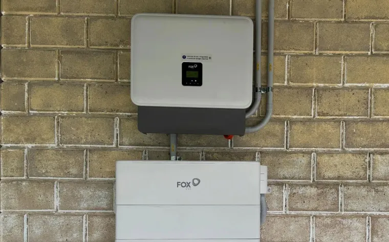 FoxESS inverter and battery installed on a cream brick wall